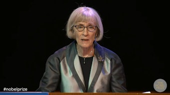 Claudia Goldin speaking at a podium