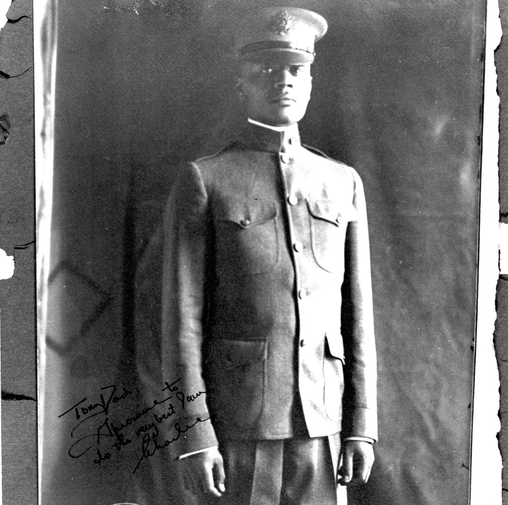 A military portrait of Houston, in his First Lieutenant uniform, in the World War I era. The portrait is signed “To my Dad, I promise to do the very best I can. Charlie.”