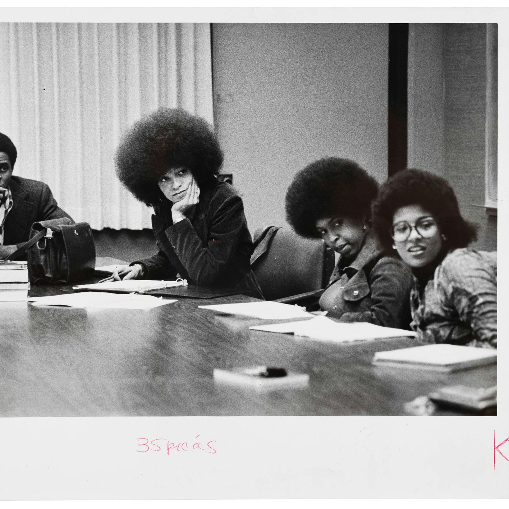 Angela Davis sitting in class with 3 others.