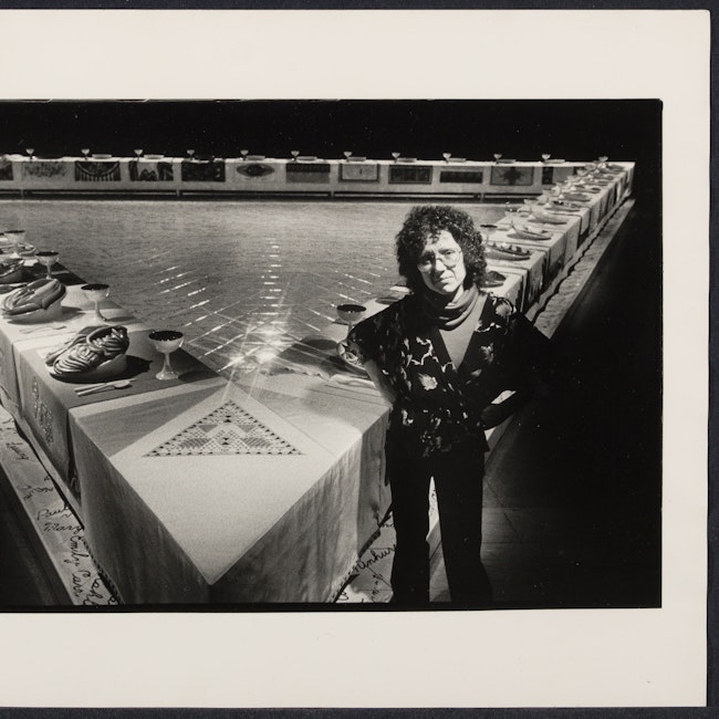 Artist Judy Chicago stands in front of her work "The Dinner Party"