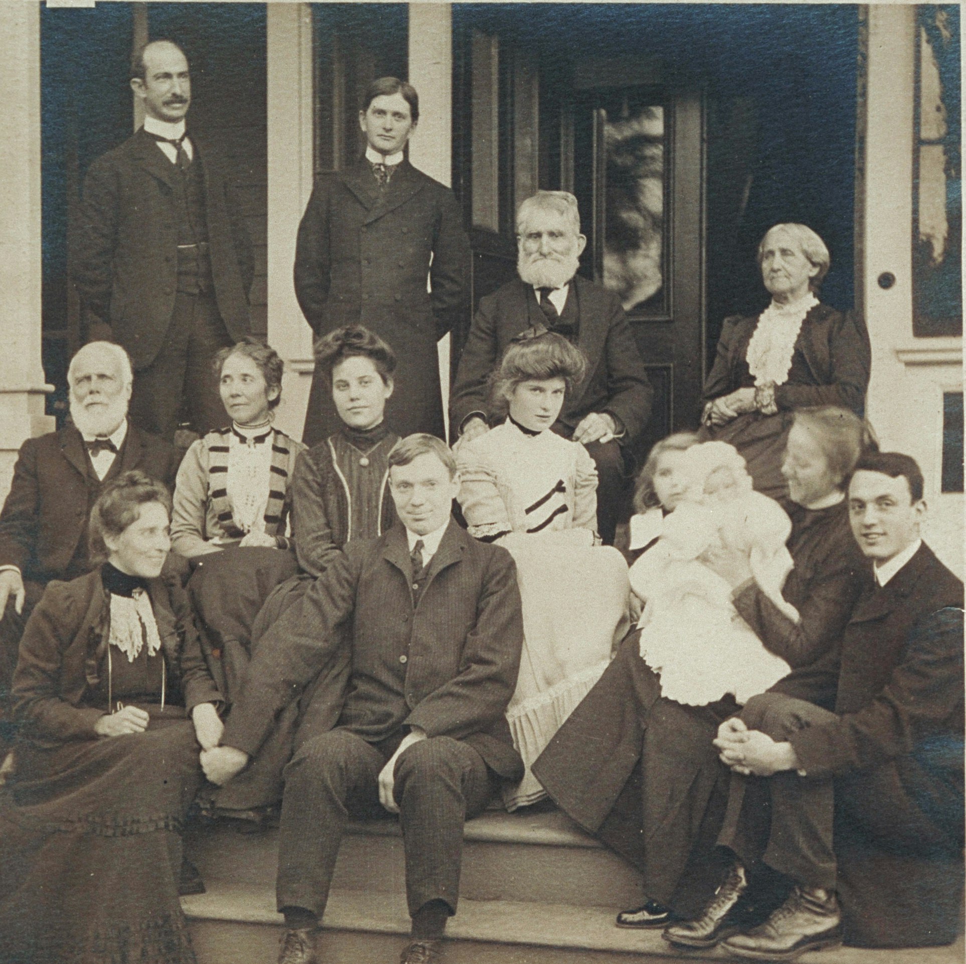 Group portrait of members of the Blackwell family on a dwelling porch