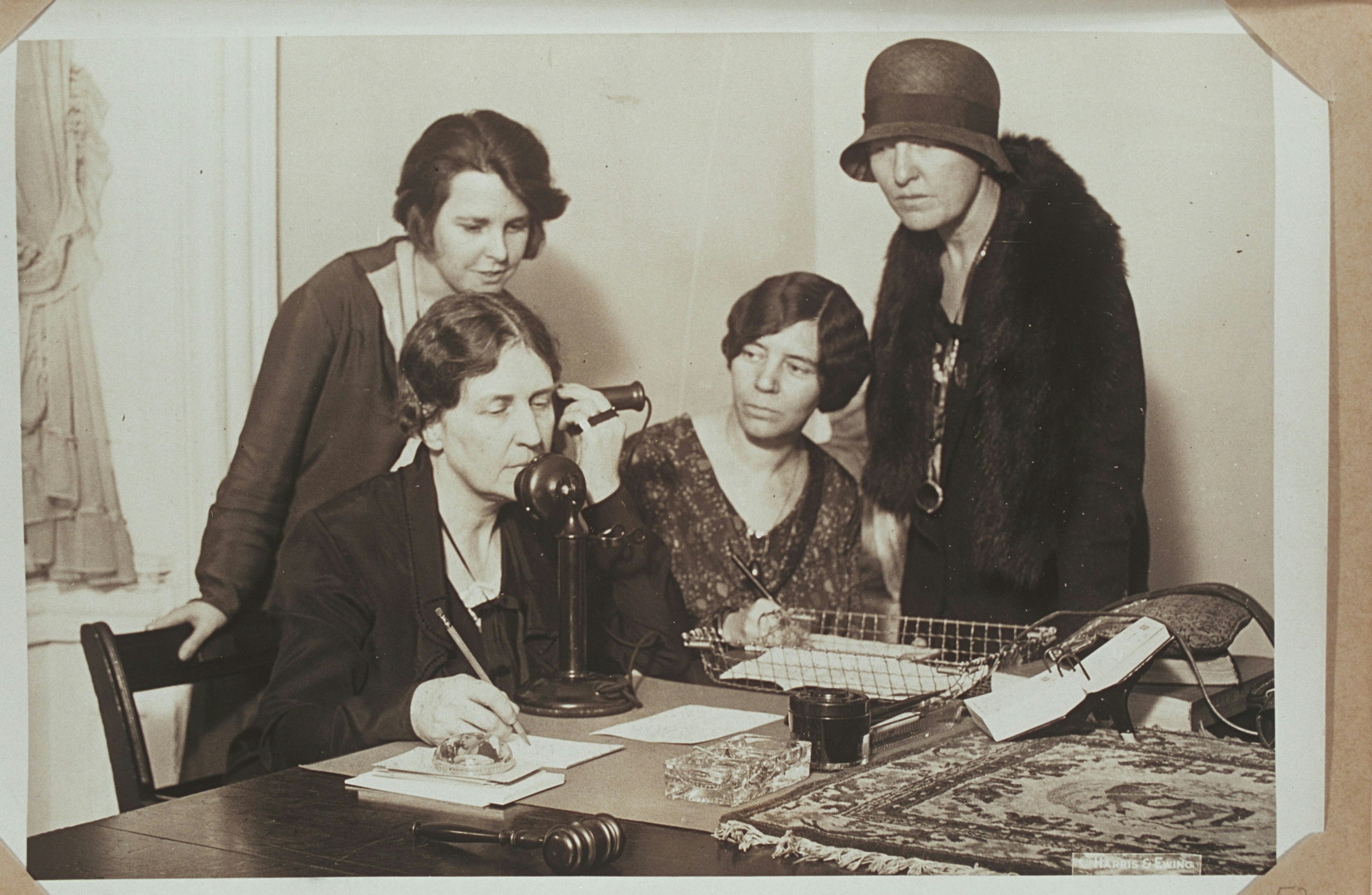 Anna Wiley telephoning Doris Stevens accompanied by other women