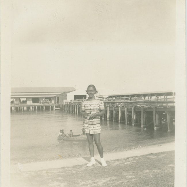 Dorothy West standing in front of a pier at Oak Bluffs beach on Martha's Vineyard