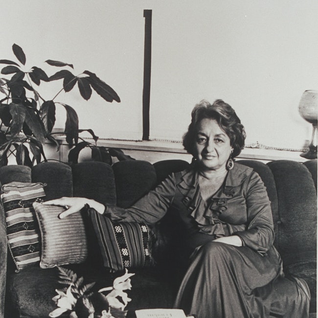 Betty Friedan, seated with copies of her book