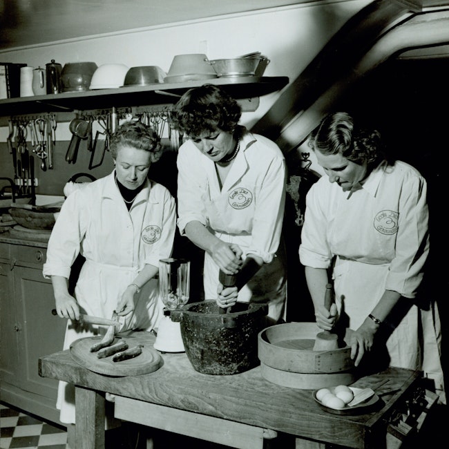 Simone Beck, Julia Child, and Louisette Bertholle cook fish at the Ecole des Trois Gourmandes