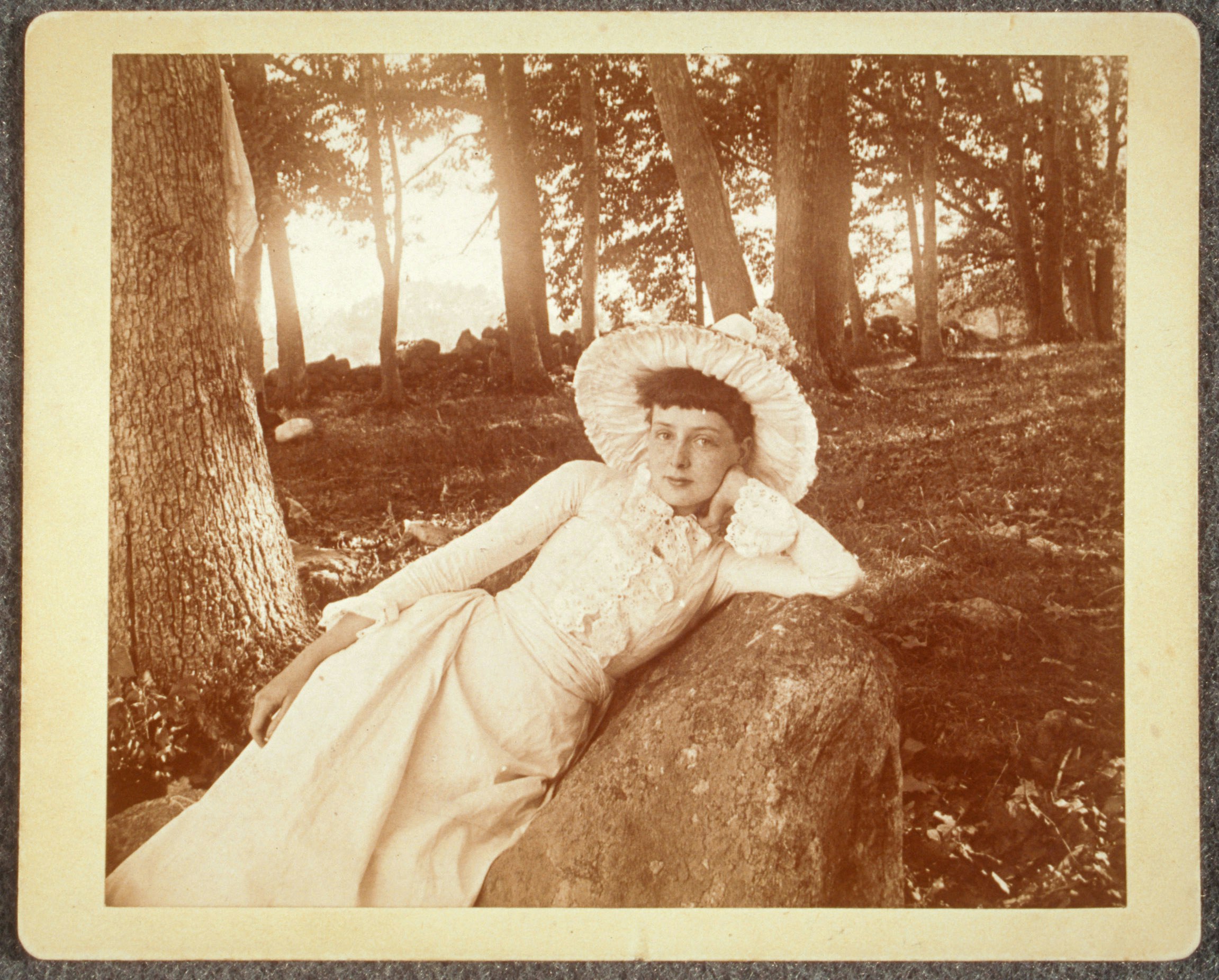 Maud Wood laying on rock, outdoors