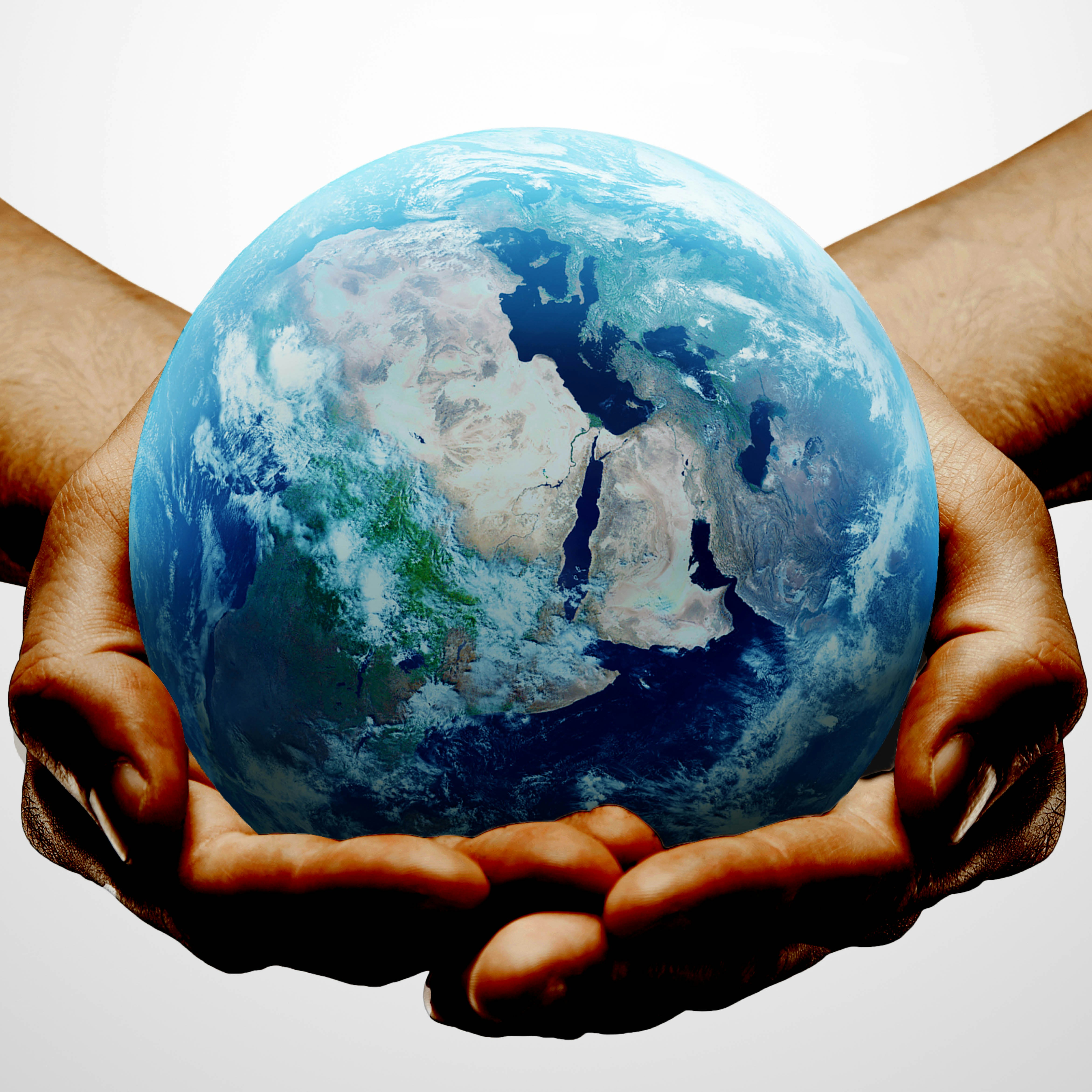Photo of the earth cradled in a pair of hands.