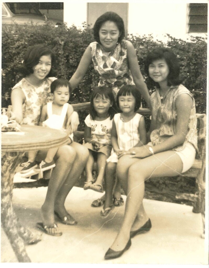 Sepia toned image of  Sharon Bromberg-Lim with family and friends in backyard