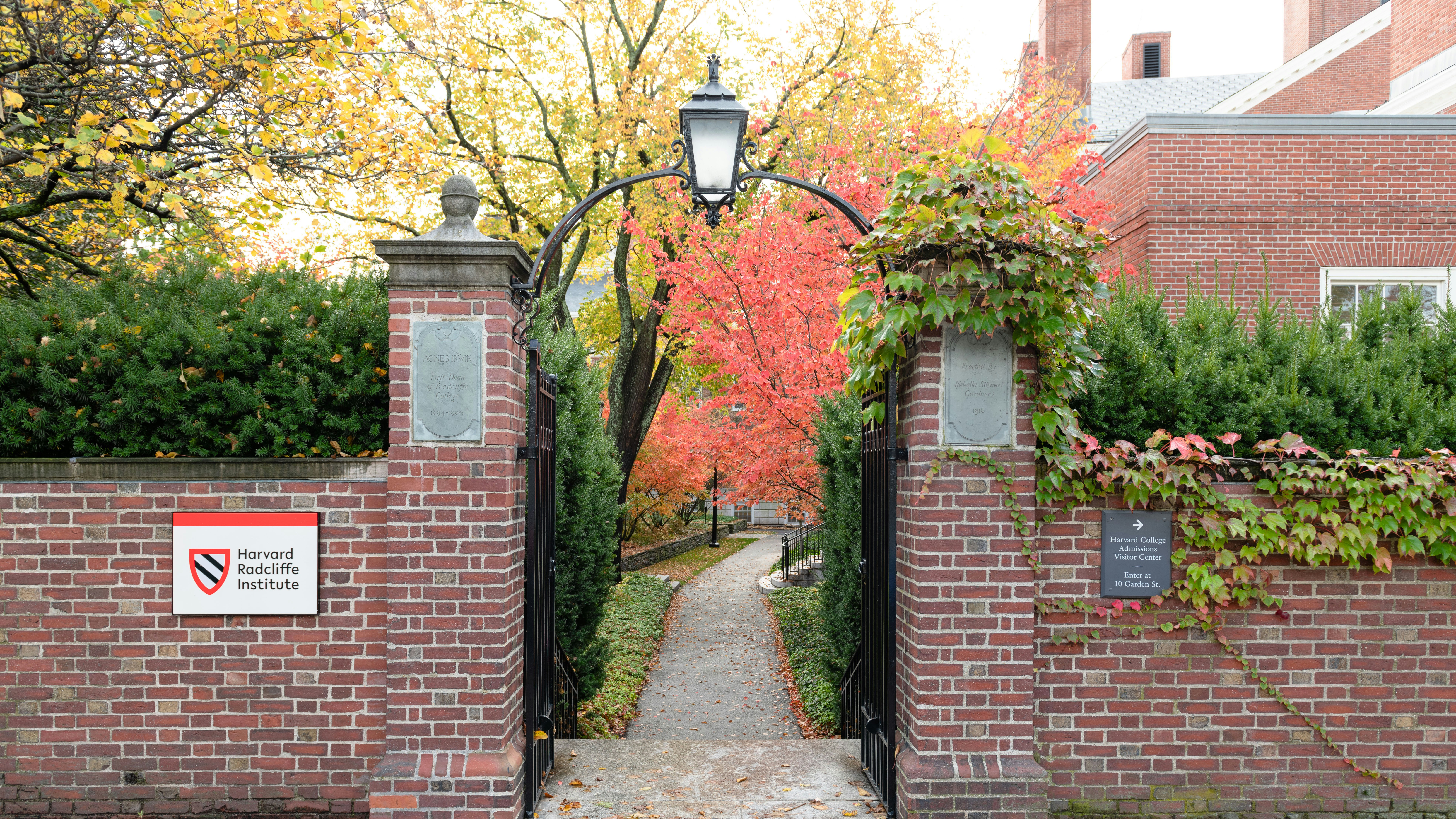 Brick-walled entry to a pathway leading into Radcliffe Yard in autumn