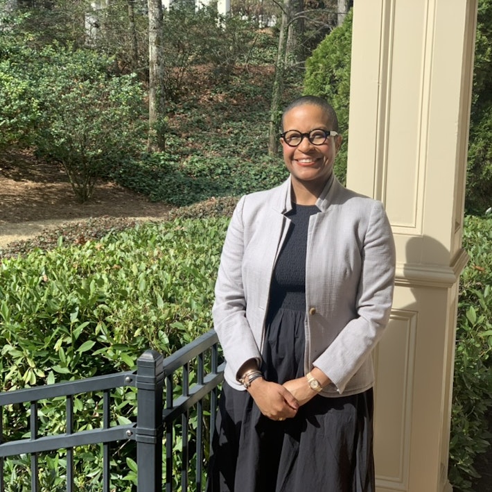 Chassidy Winestock smiles for the camera, with hands folded.