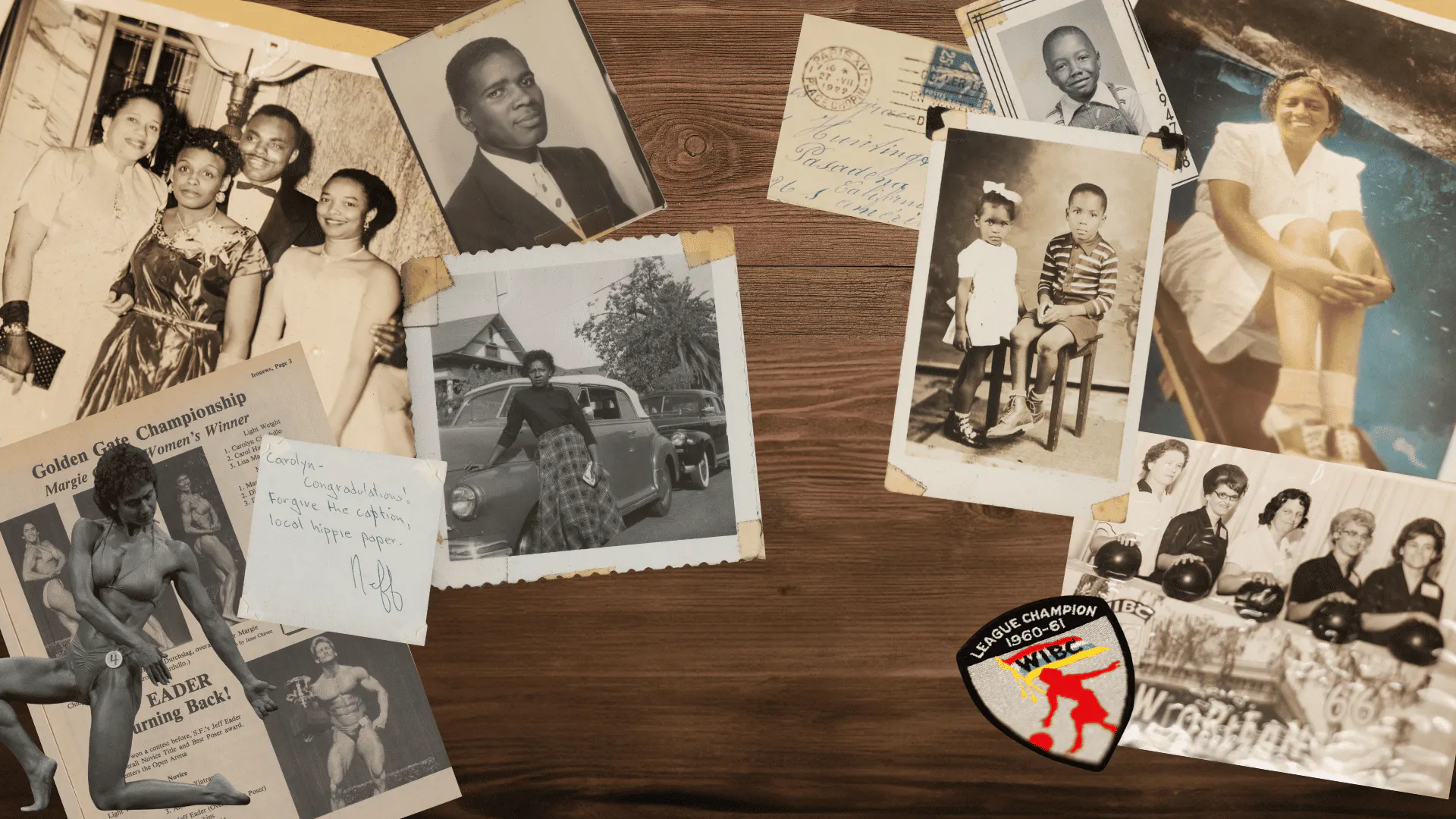 A number of vintage photographs, notes, postcards, and badges arranged on a woodgrained surface