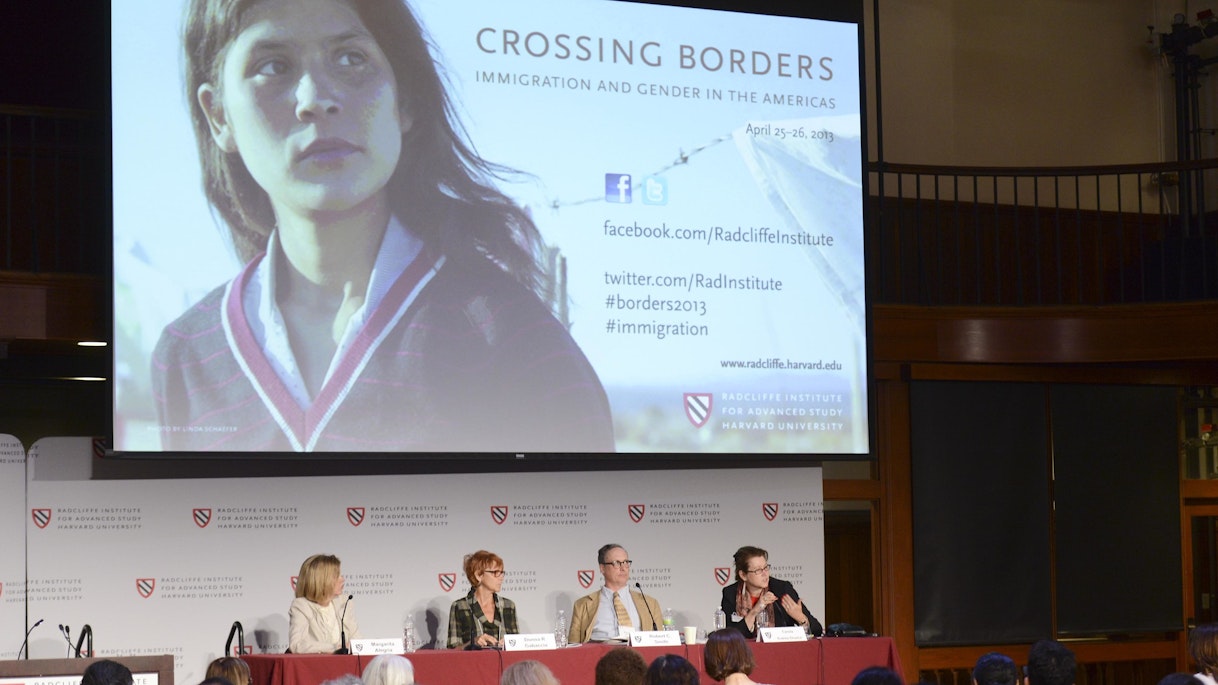 Margarita Alegria, Donna R. Gabaccia, Robert C. Smith, and Carola Suárez-Orozco sit at a panel table. A screen hanging above them reads,