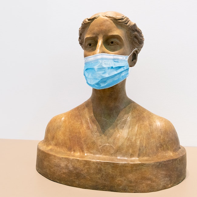 A 1917 plaster bust of Charlotte Perkins Gilman, which sits in the Pforzheimer Reading Room, wears a disposable face covering.