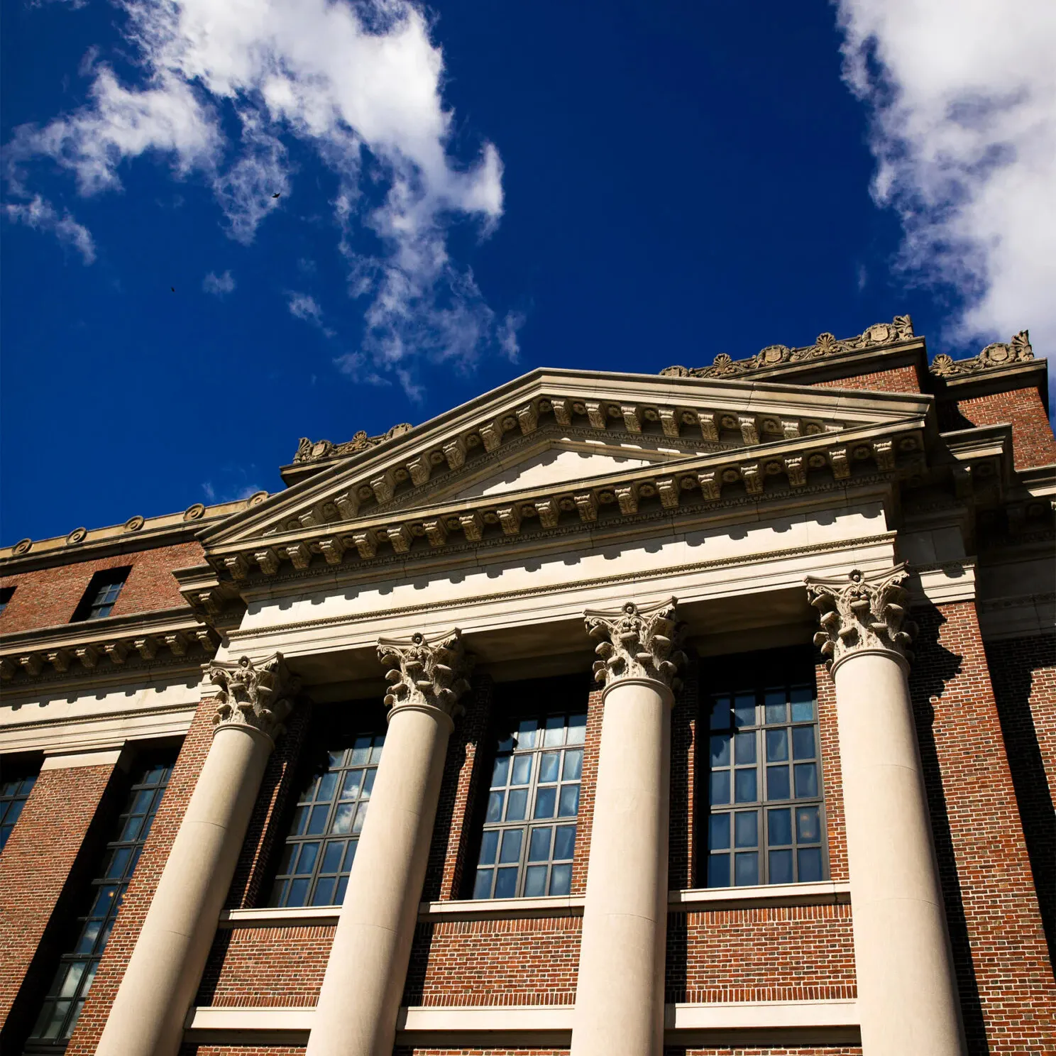 An old building with large, stately columns under a clear sky.