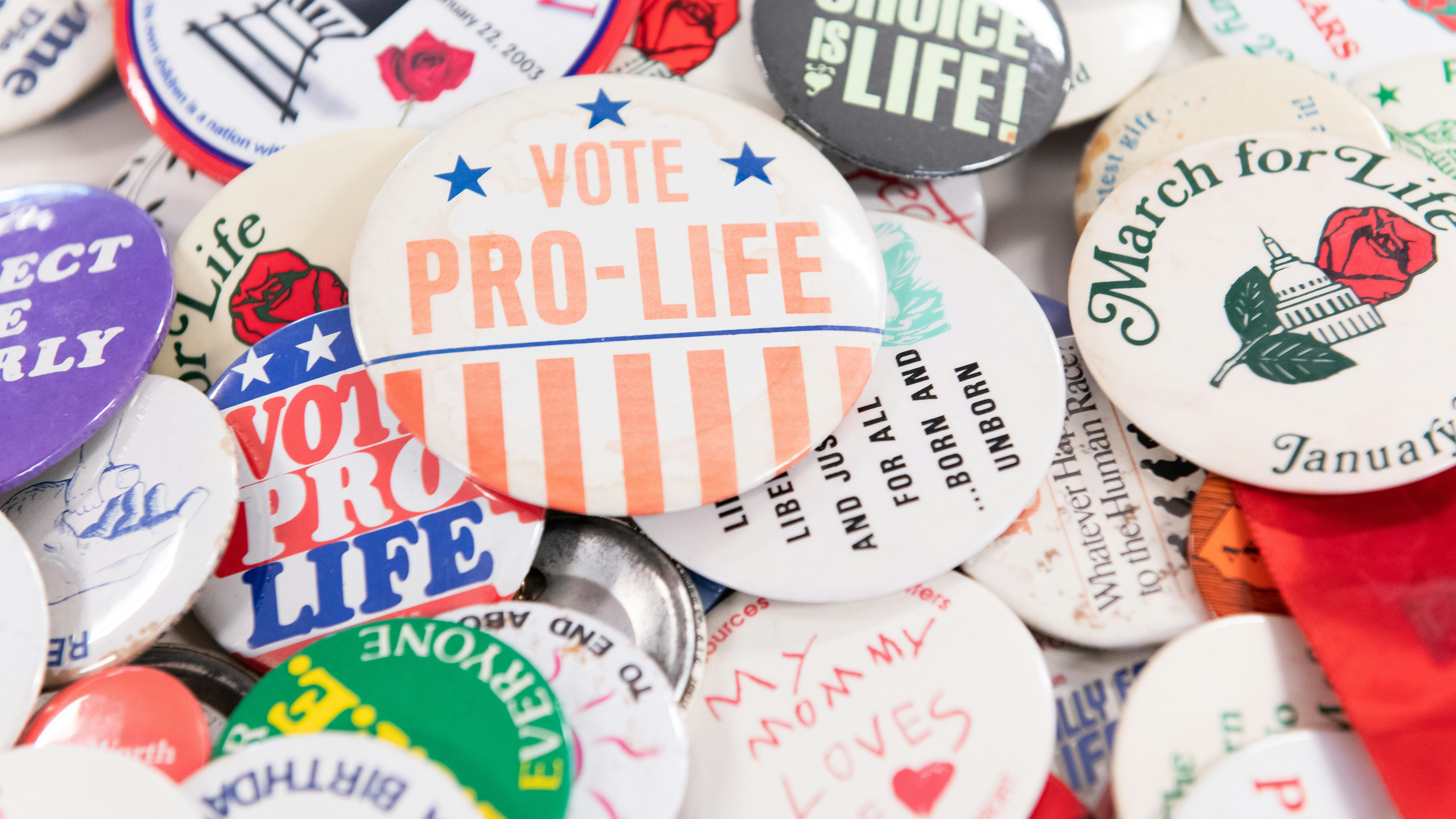 A pile of colorful buttons advertising pro-life slogans