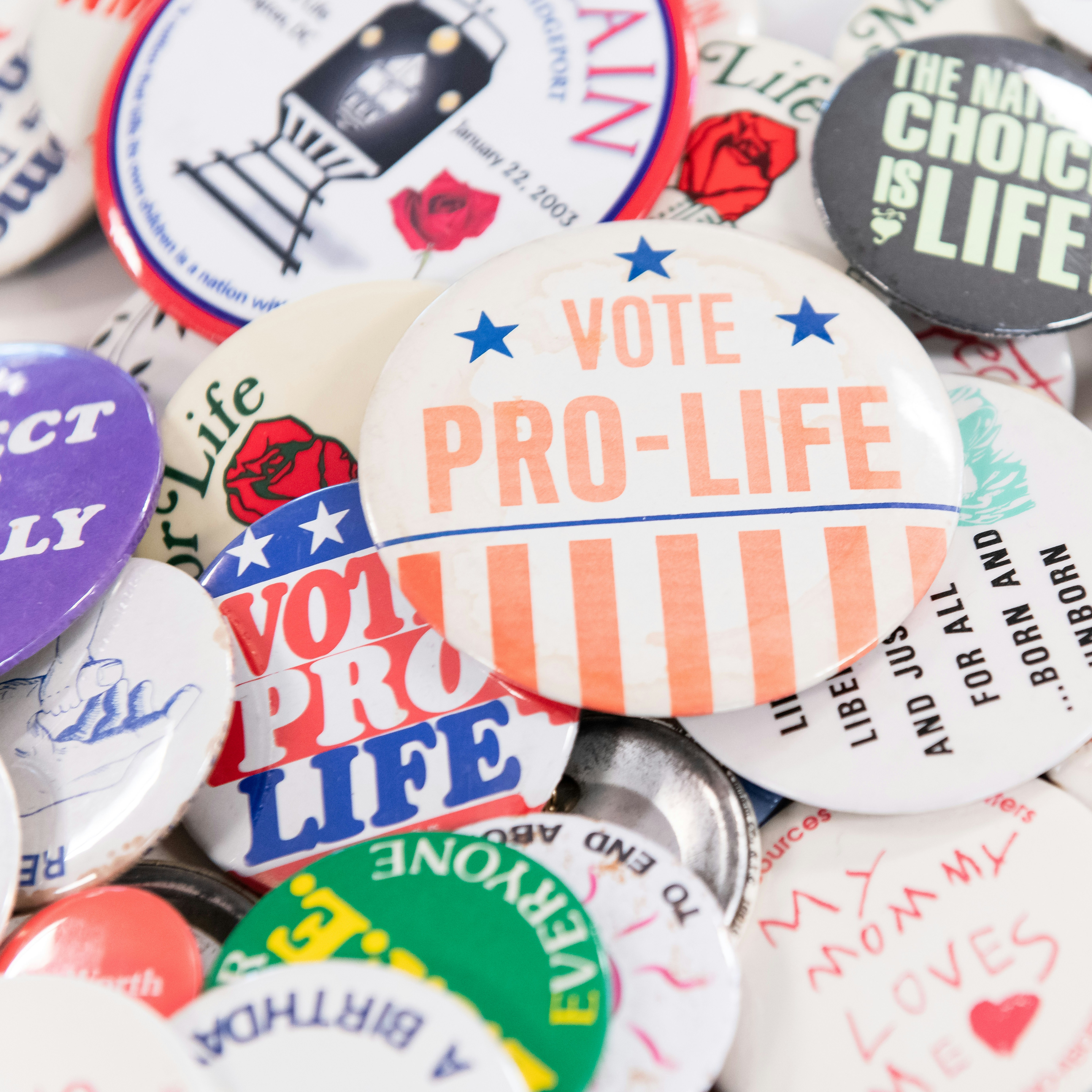 A pile of colorful buttons advertising pro-life slogans