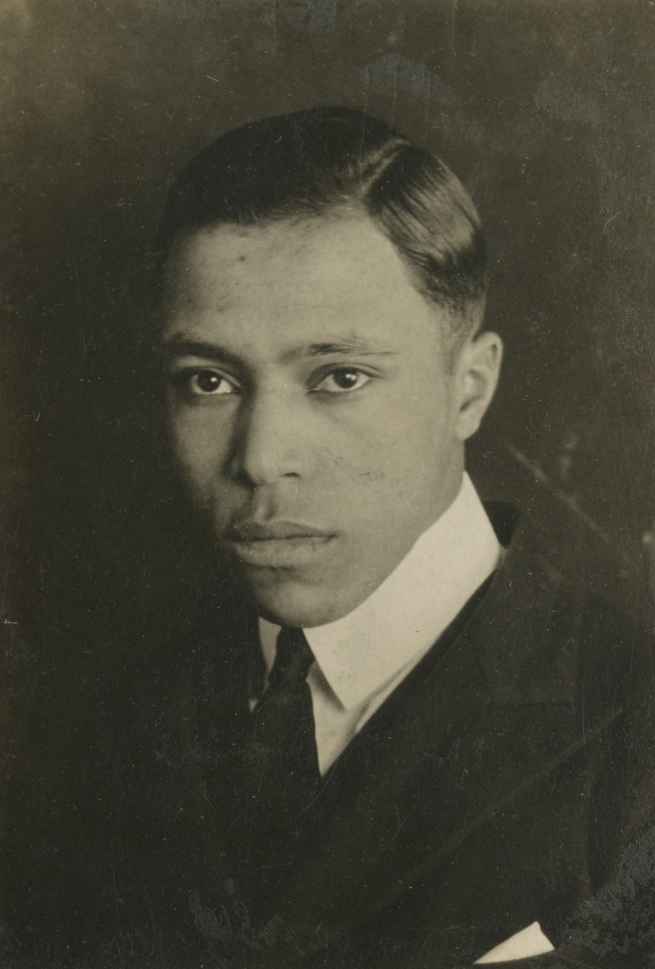 Sepia head shot of a young Edwin B. Jourdain, Jr., wearing suit and tie.