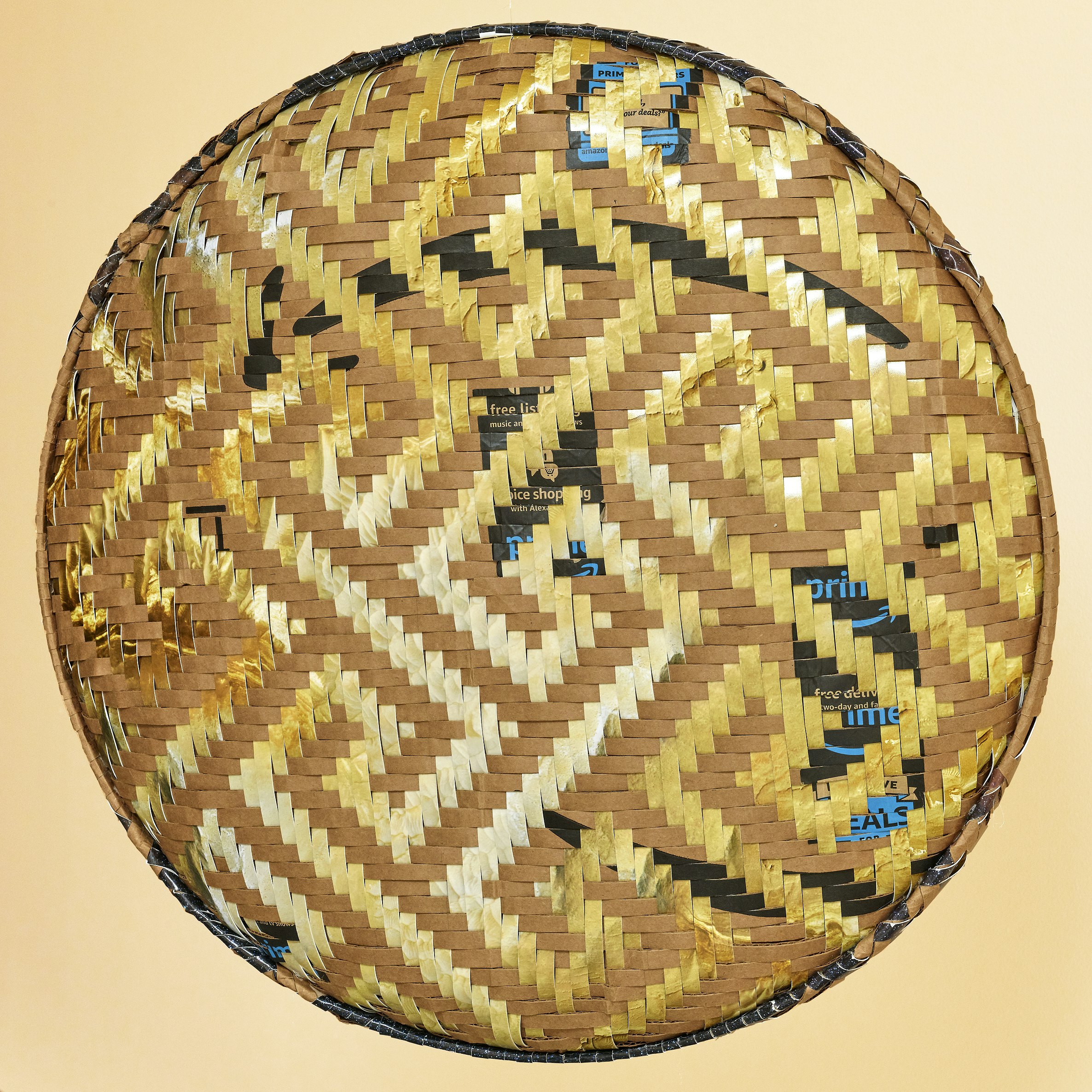 A woven basket created from Amazon.com boxes and archival inkjet prints on glossy photo paper