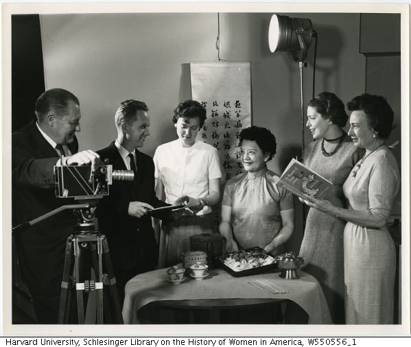 Black and white image of Grace Chu and others with camera and lighting