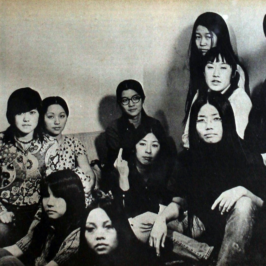 Black and white image of Asian American activists seated around