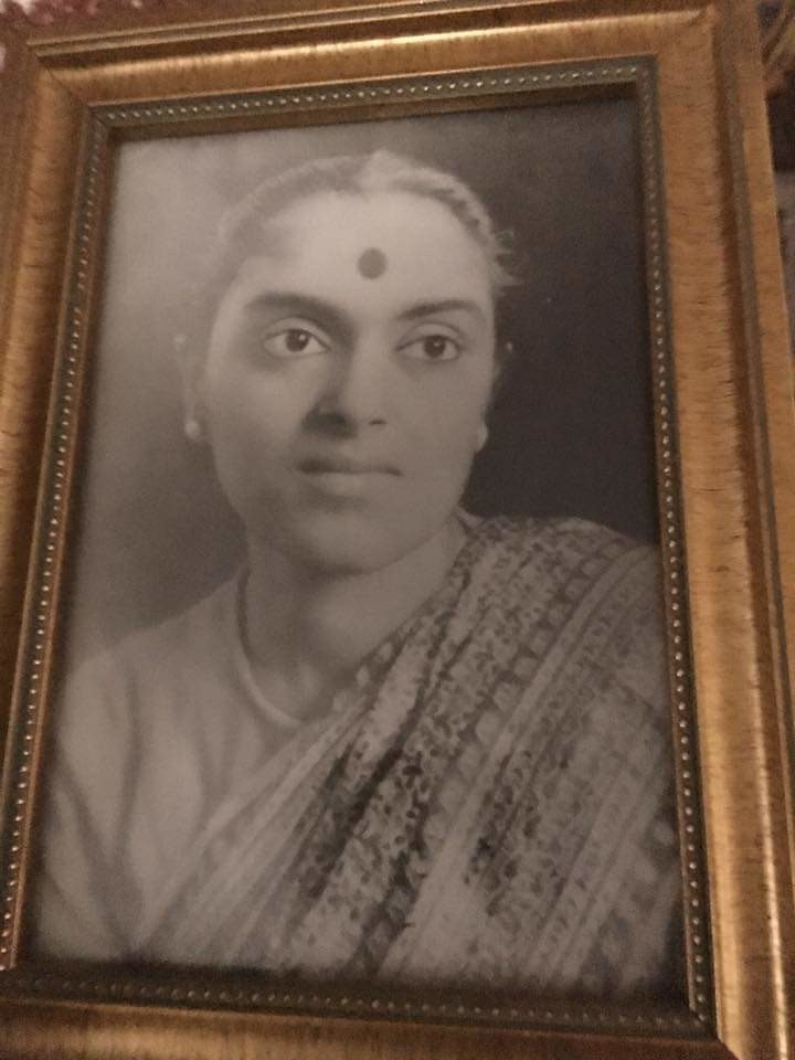 Black and white portrait with gold frame of Sinha Manishas's mother