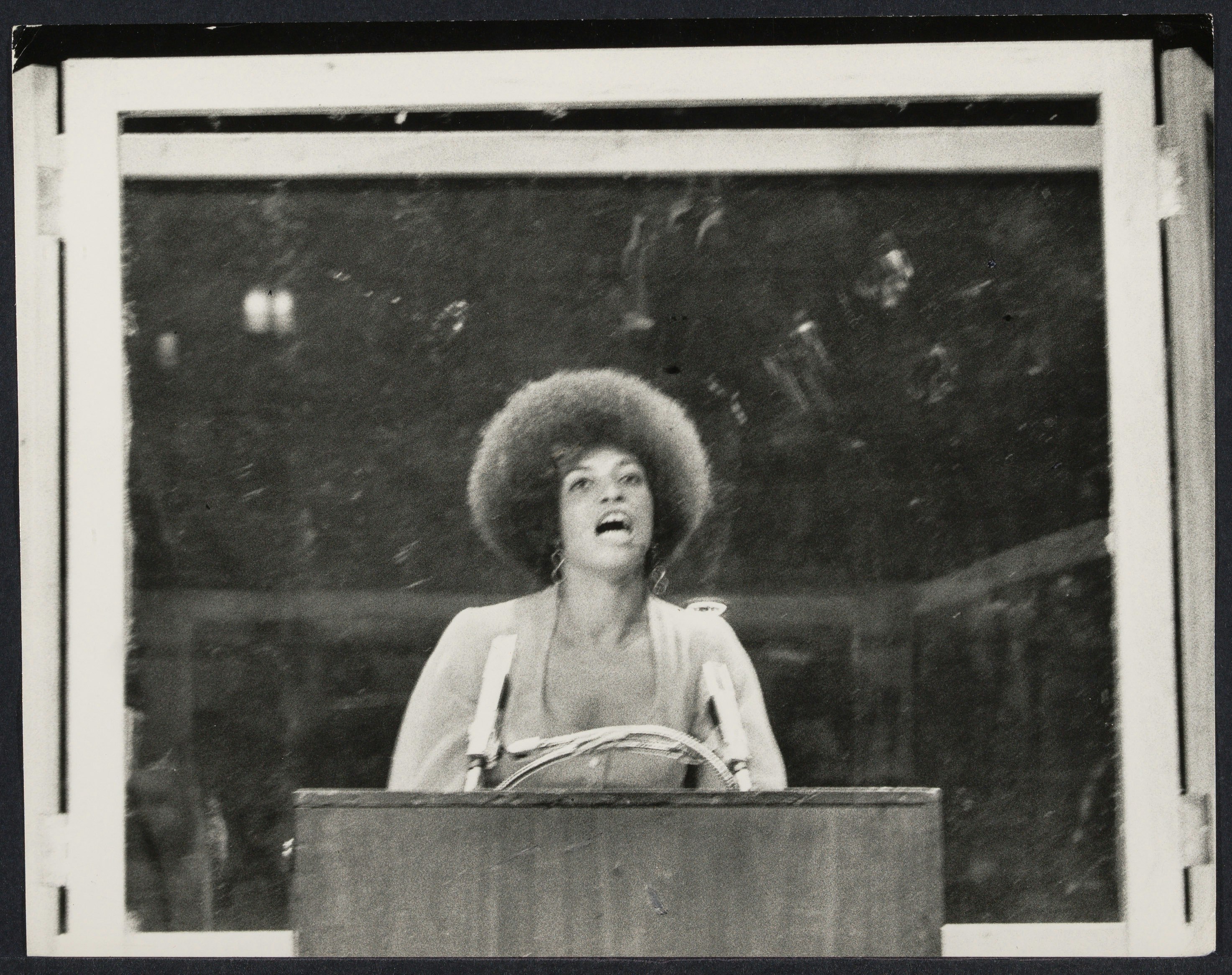 Bullet proof cage surrounds Angela Davis as she performs in "Night with Angela Davis" at Madison Square Garden