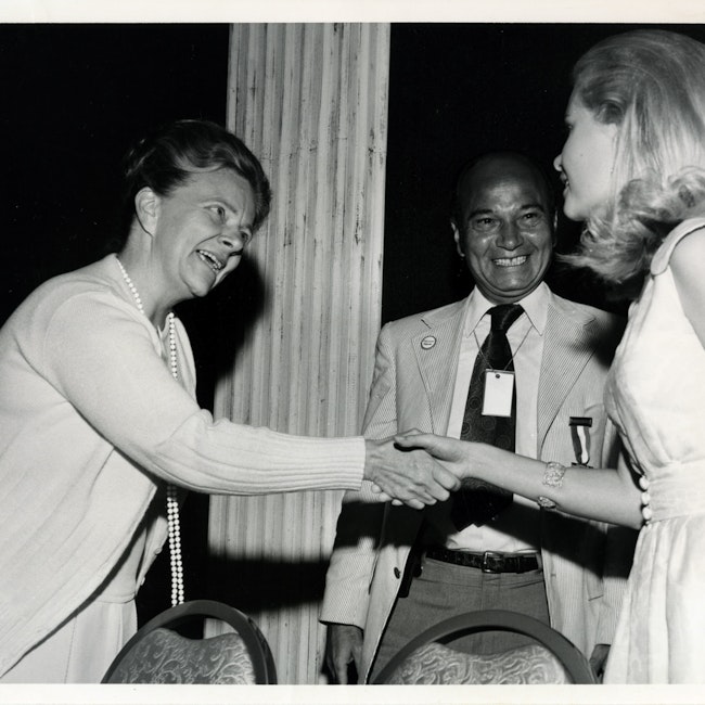 Eunice Howe shaking Esther Peterson's hand