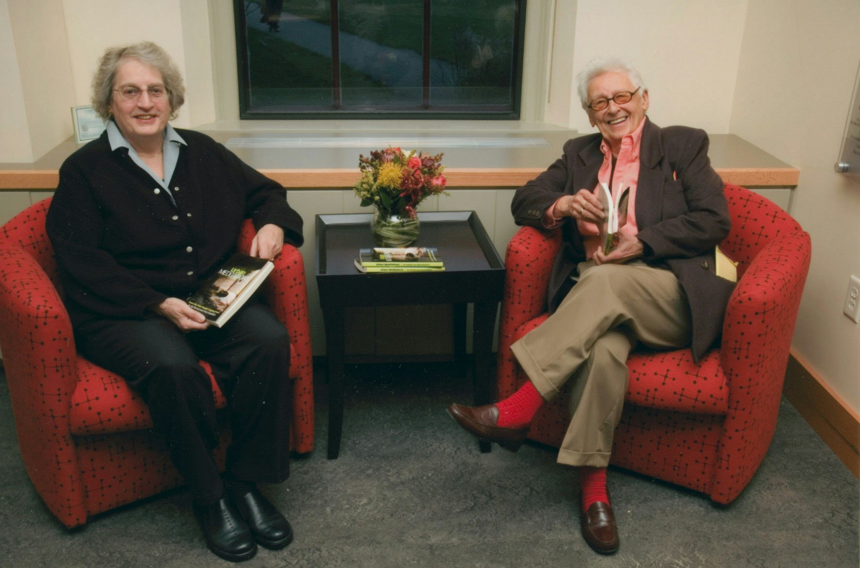 Kip Tiernan and Fran Froehlich sitting in red chairs at Schlesinger Library