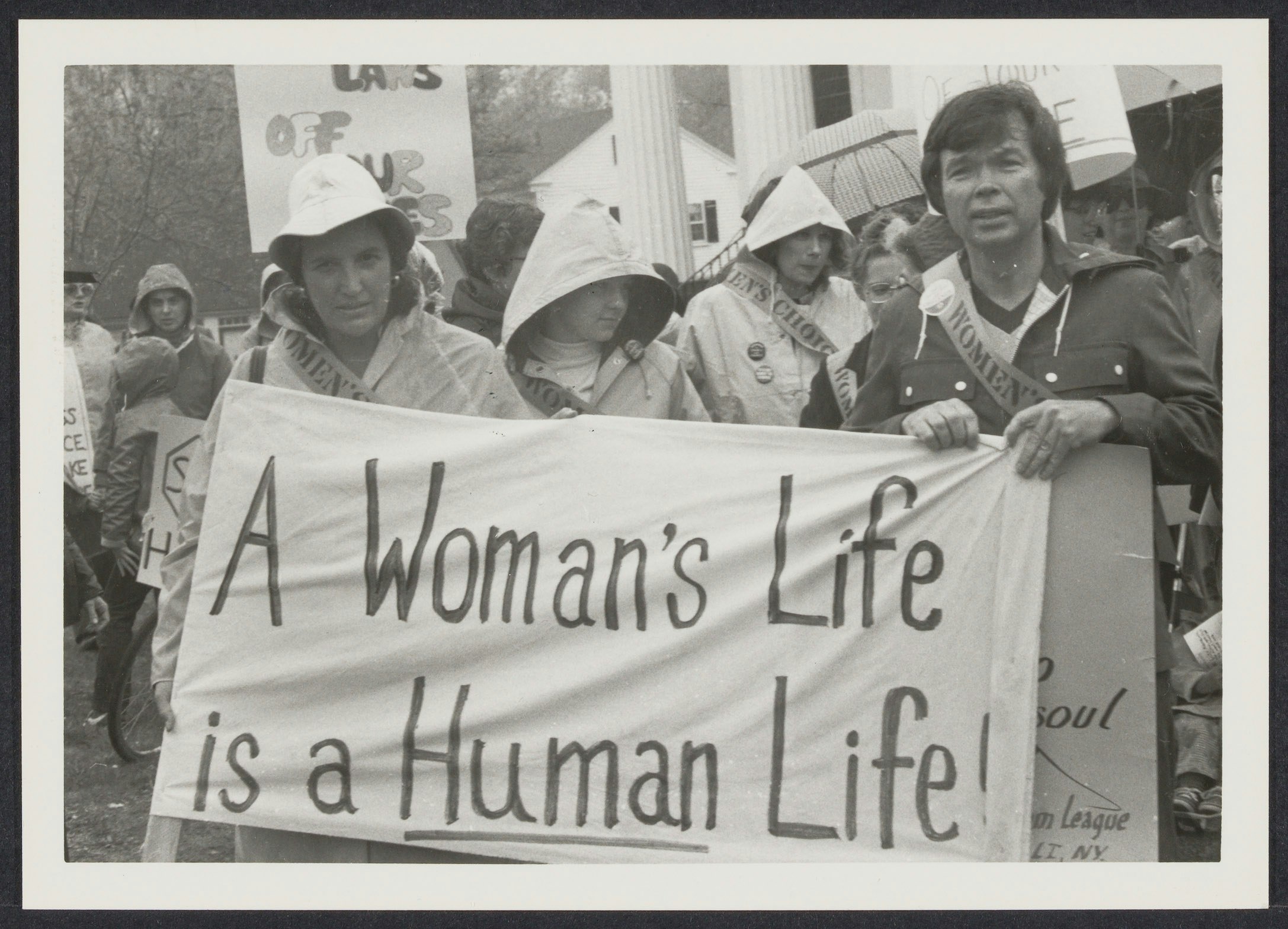 Norma Swenson (left) and Bill Baird (right) holding banner that states "A Woman's Life is a Human Life" at event