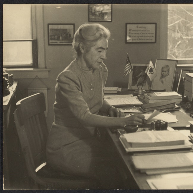 Miriam Van Waters sitting in her office.