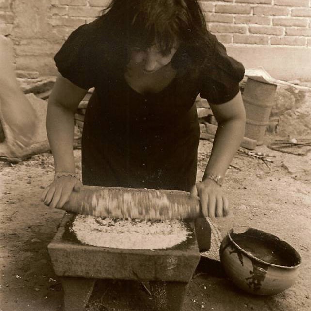 Zarela Martinez grinds cornmeal with a traditional metate in Oaxaca