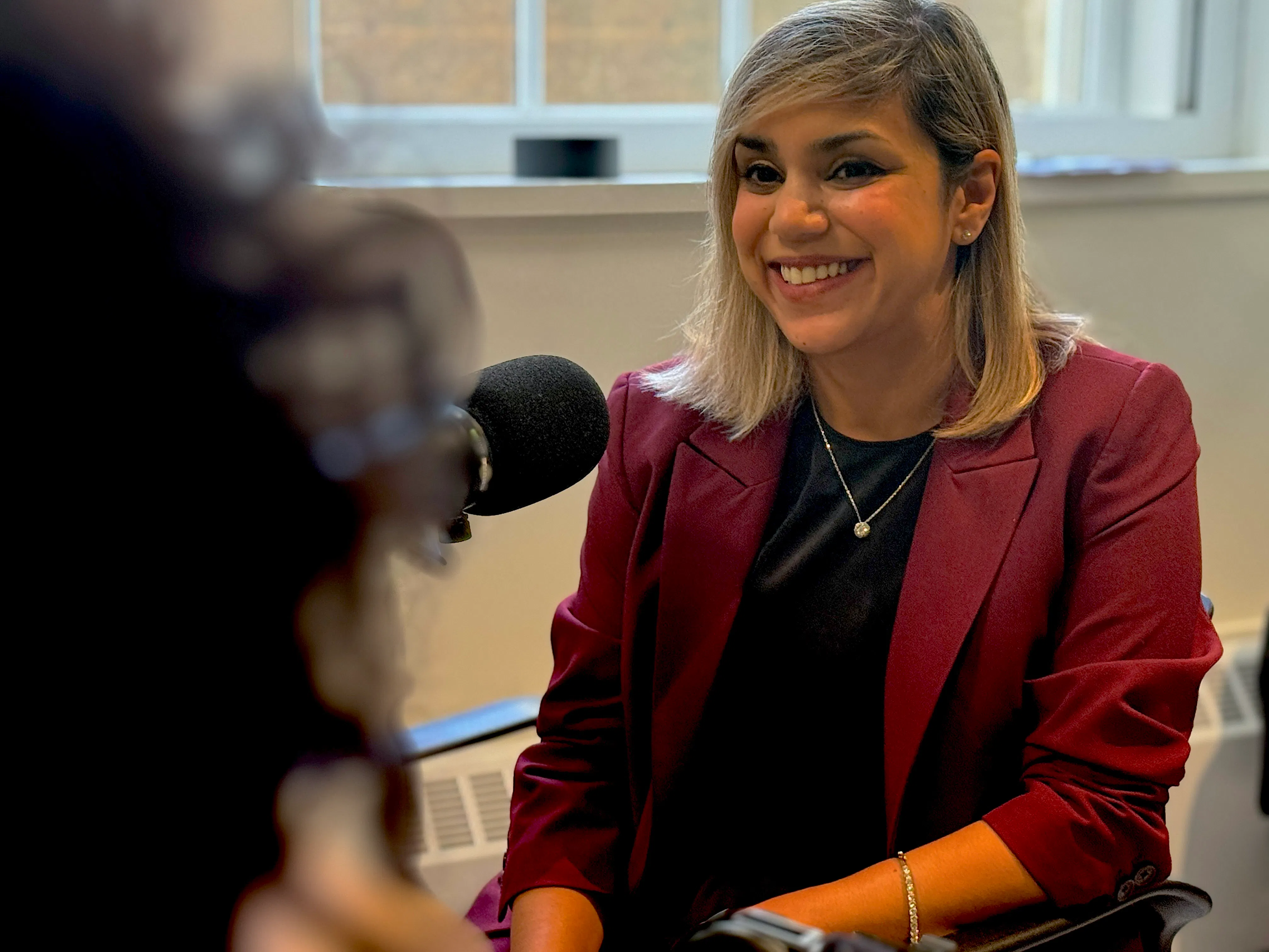 Portrait of Ashwini Nadkarni in podcast studio