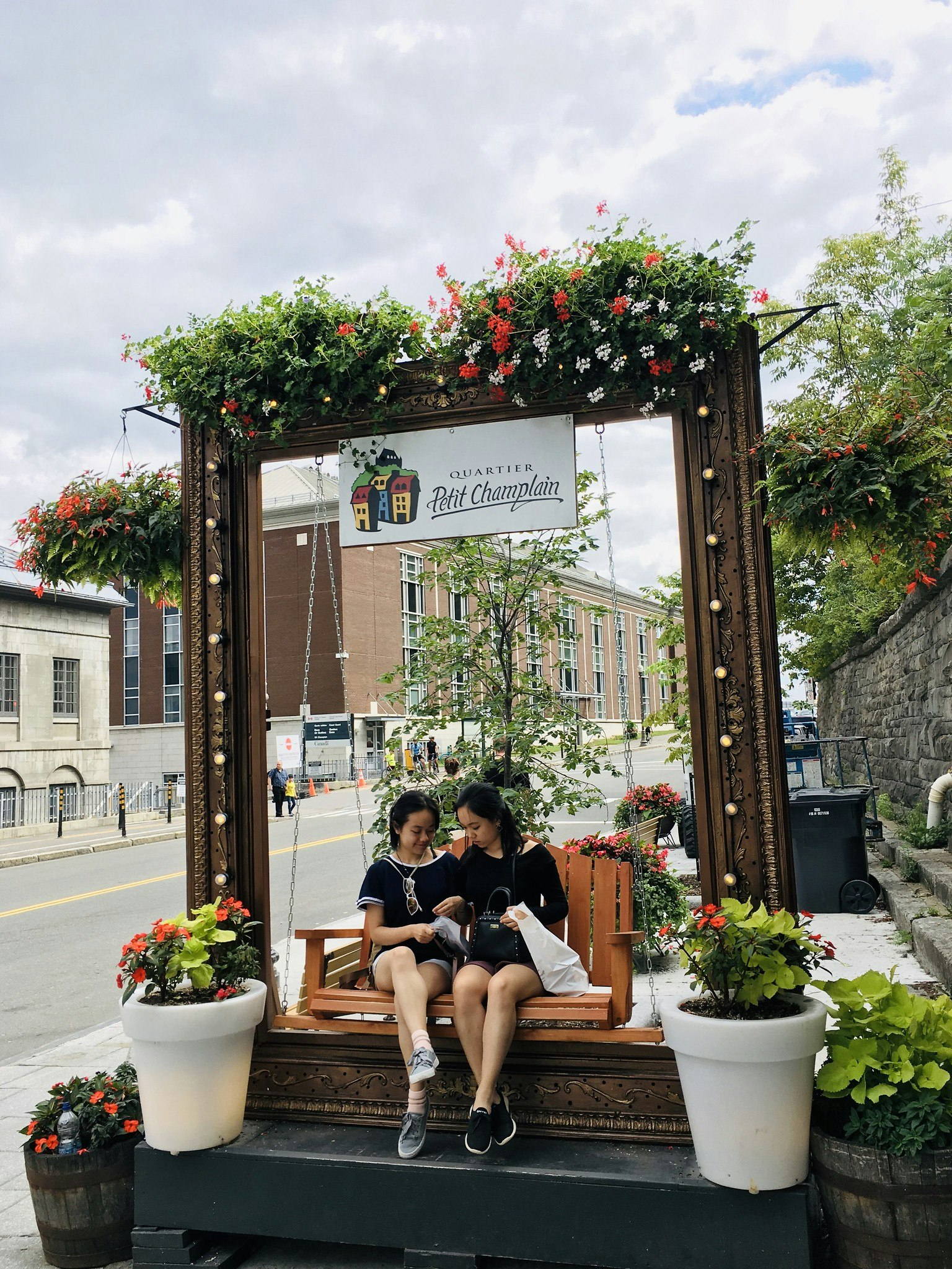 Vanessa Hu and sister sitting on a bench in Quebec City, Montreal