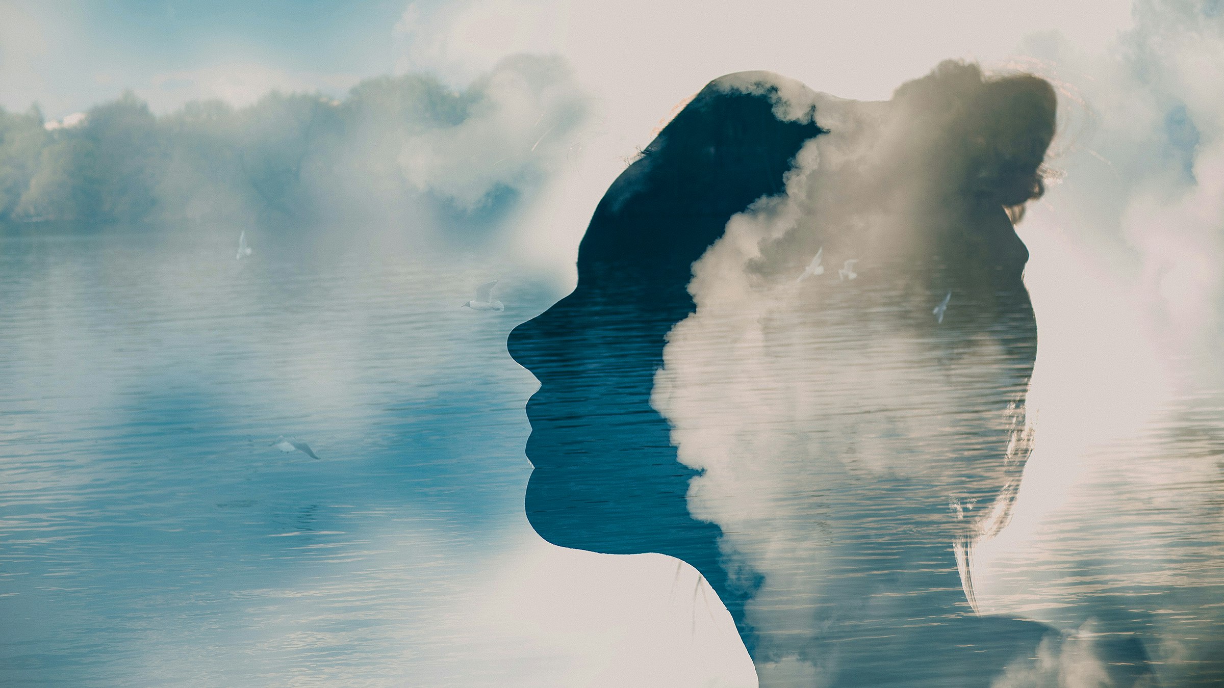 A woman in profile, her head partly obscured by clouds and a serene lake scene in the background.