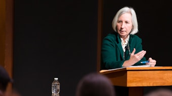 Martha Minow speaks at a podium in front of an audience.