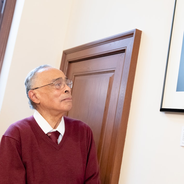 Spencer Jourdain gazes at photo portrait of his father, Edwin Bush Jourdain Jr. hanging in Winthrop House at Harvard University.