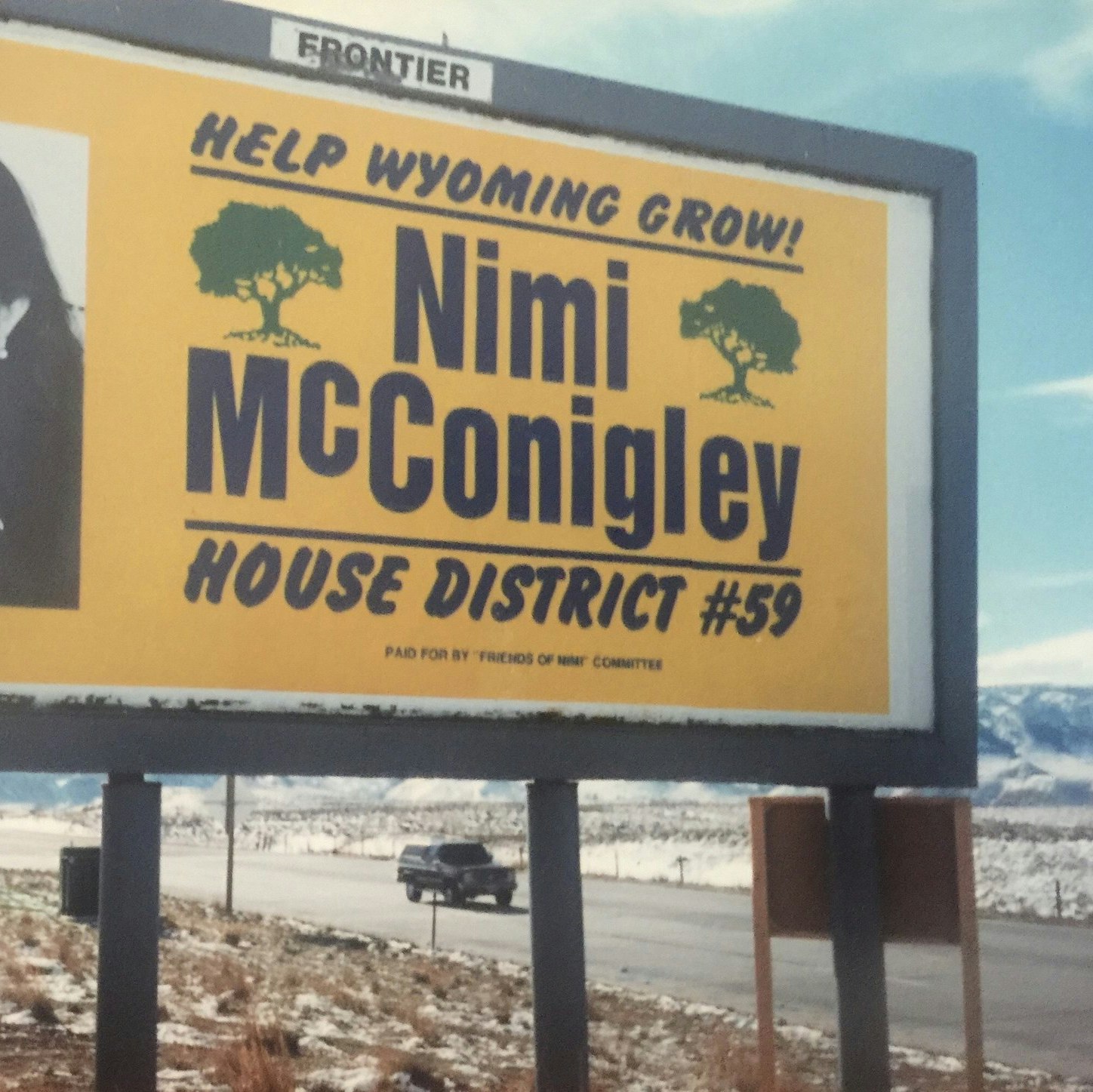 Billboard image of Nina Mcconigley's mother, Nimi McConigley, reading "Help Wyoming Grow!" and "House District #59"