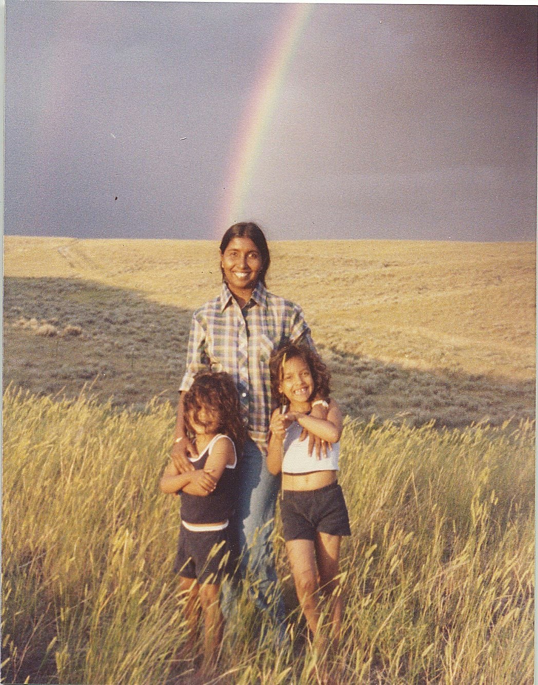 Nina McConigley with her sister when they were children, posing with their mother on the high plains of Wyoming