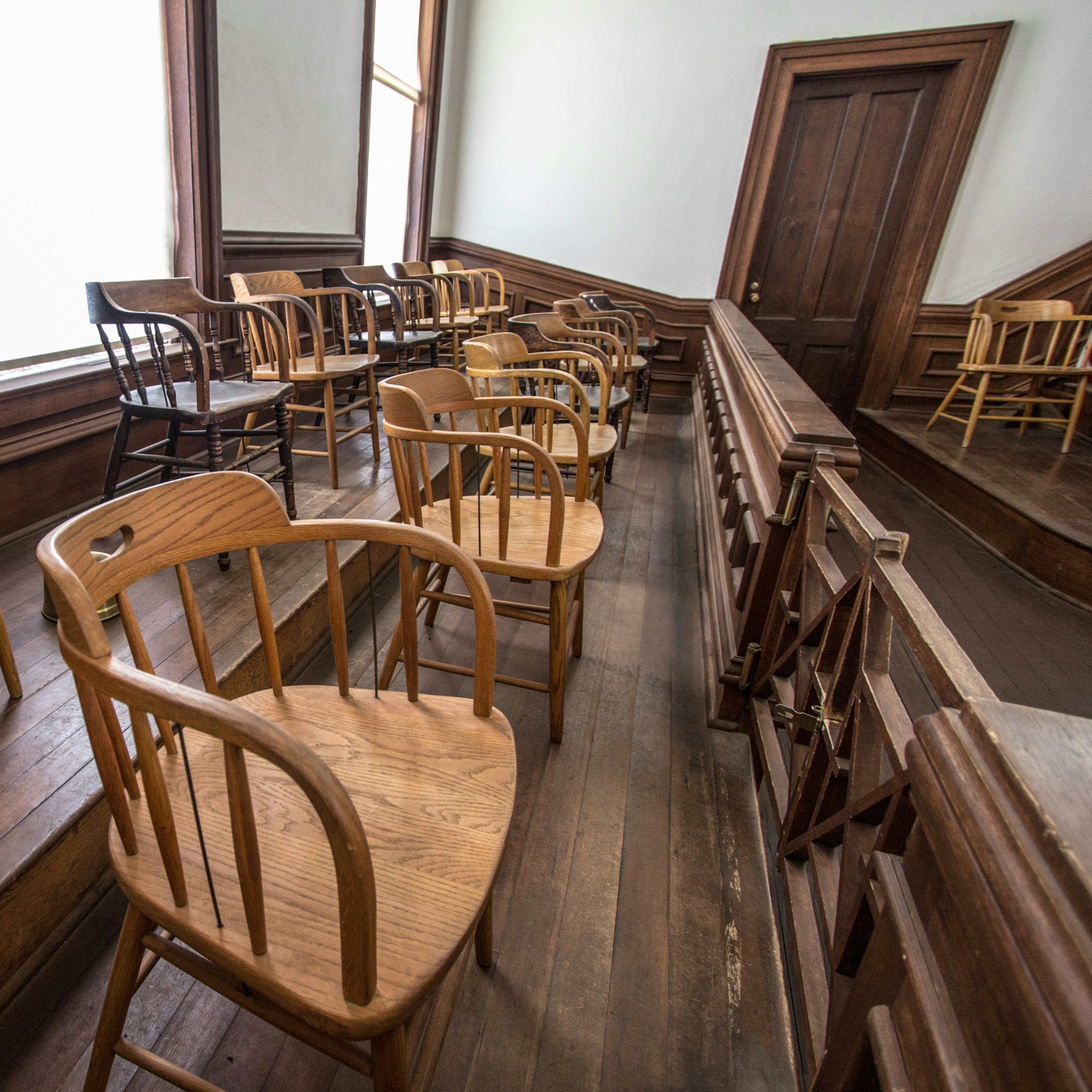 empty chairs in a jury box.