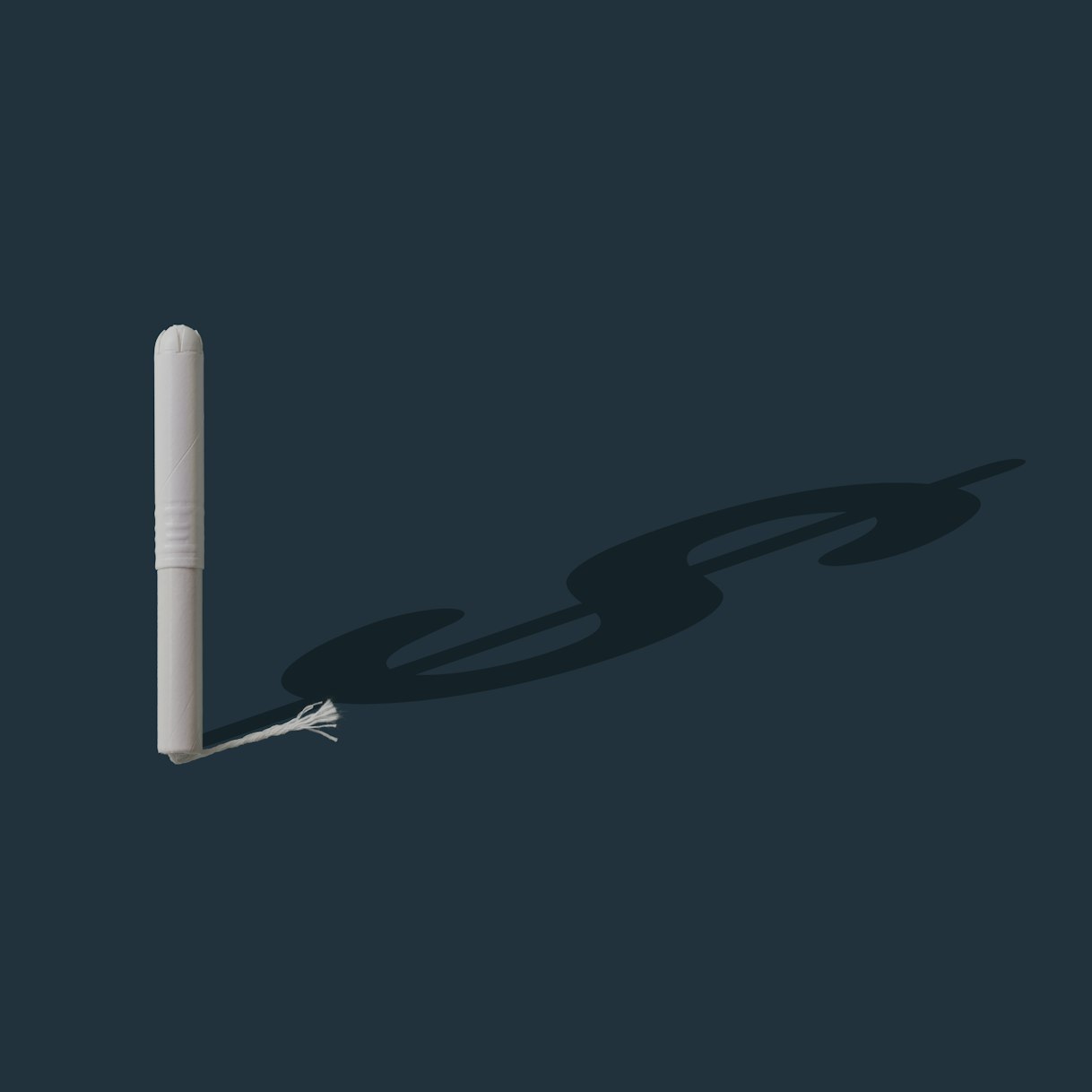 A tampon casts a dollar-sign-shaped shadow.
