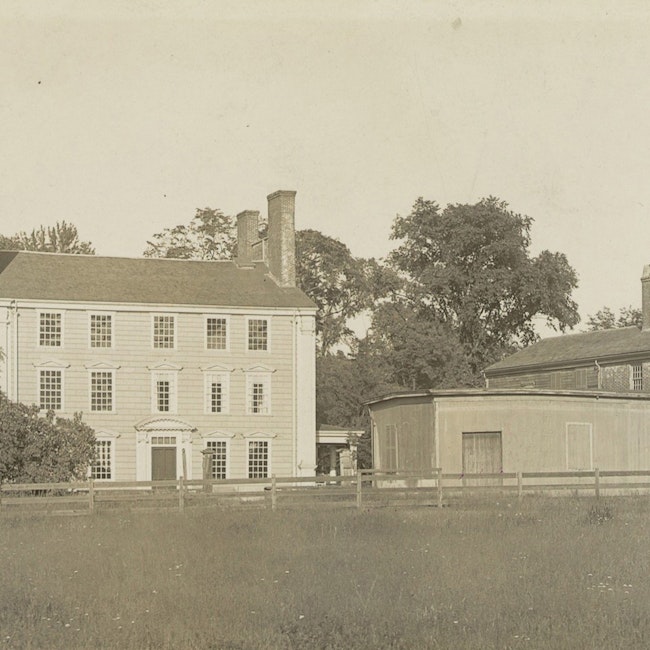 A sepia-toned photo of a mansion and slave quarters, in Medford, Massachusetts.